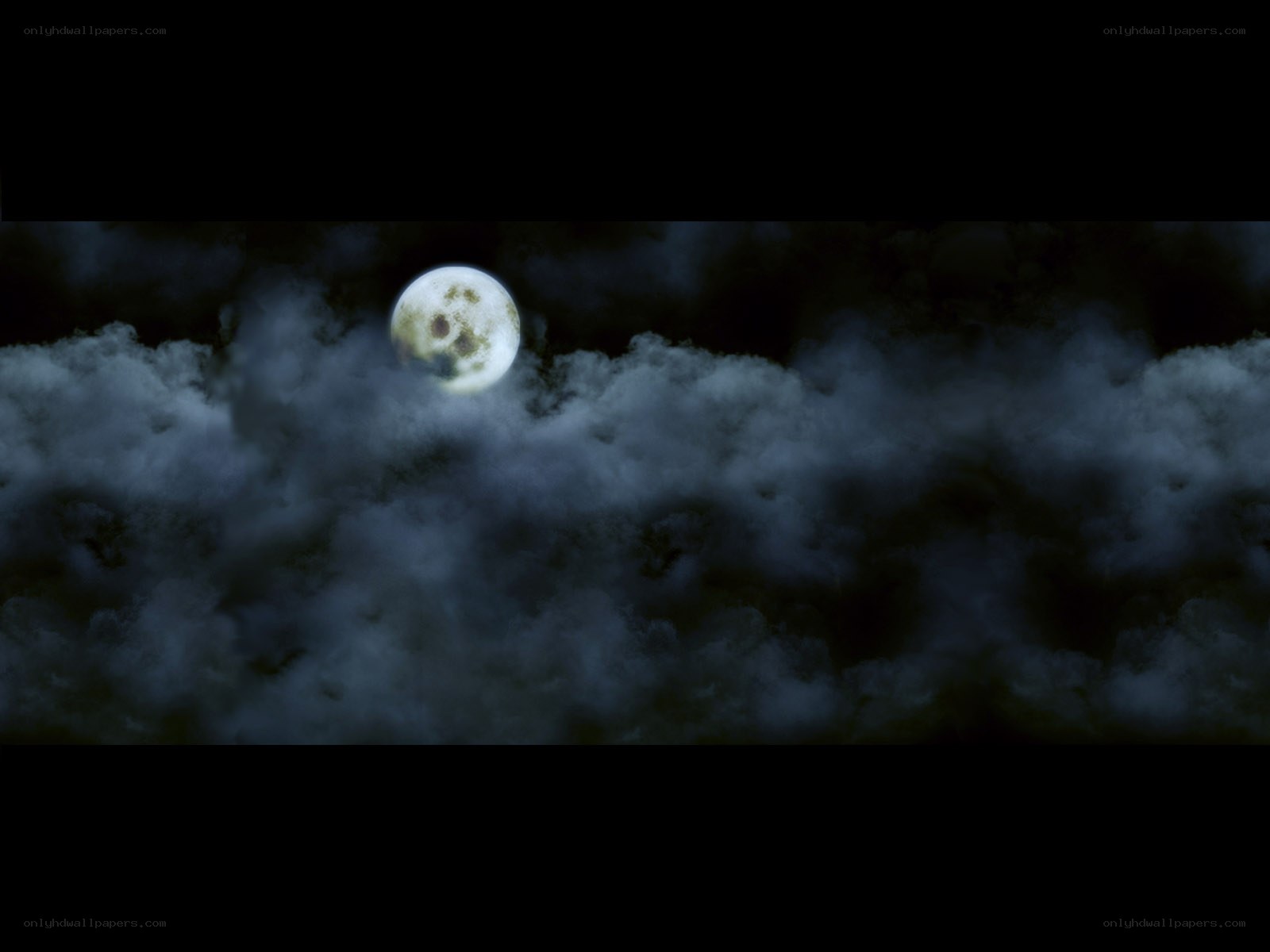 Moon behind clouds at night