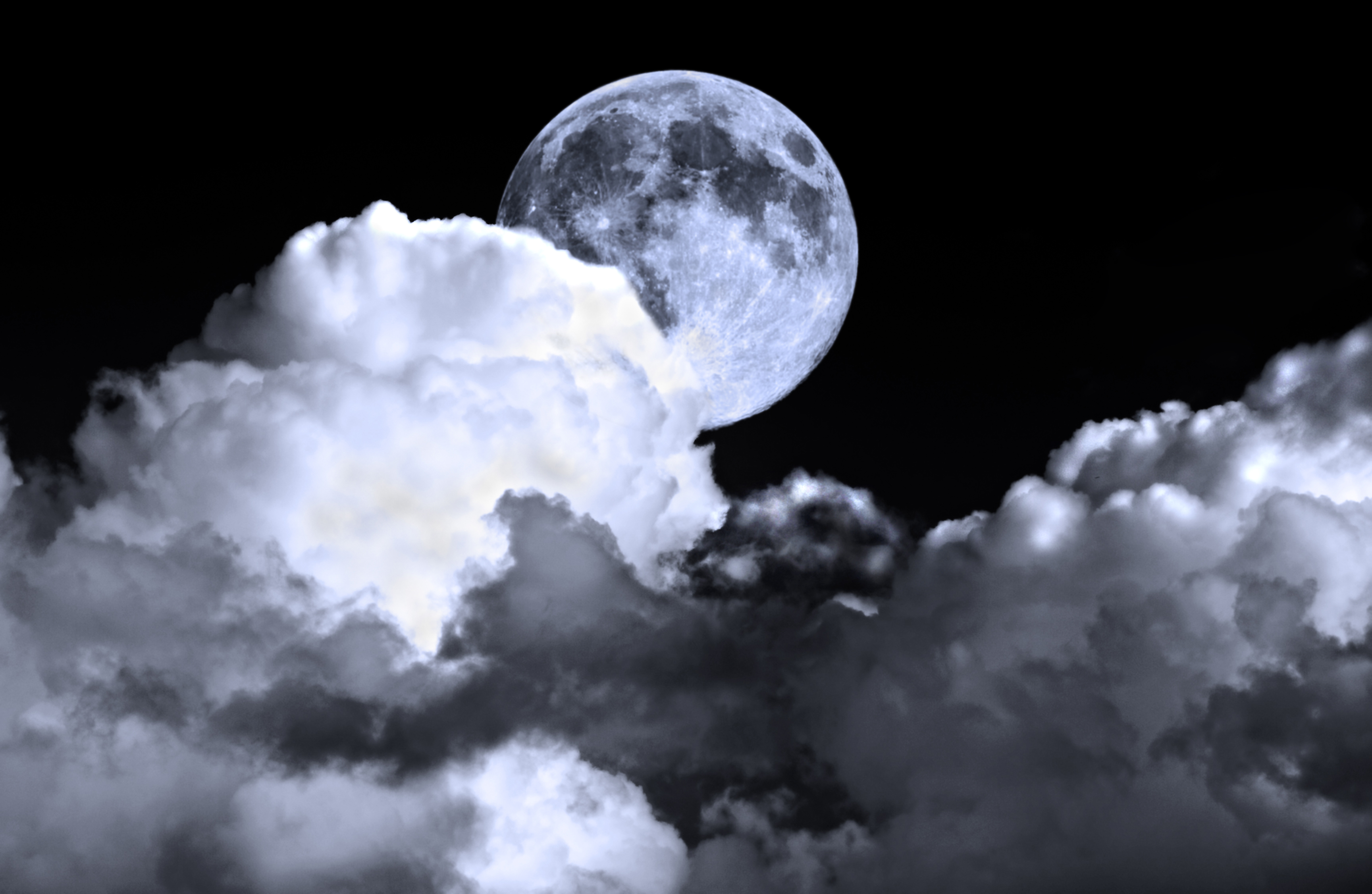Moon behind clouds at night