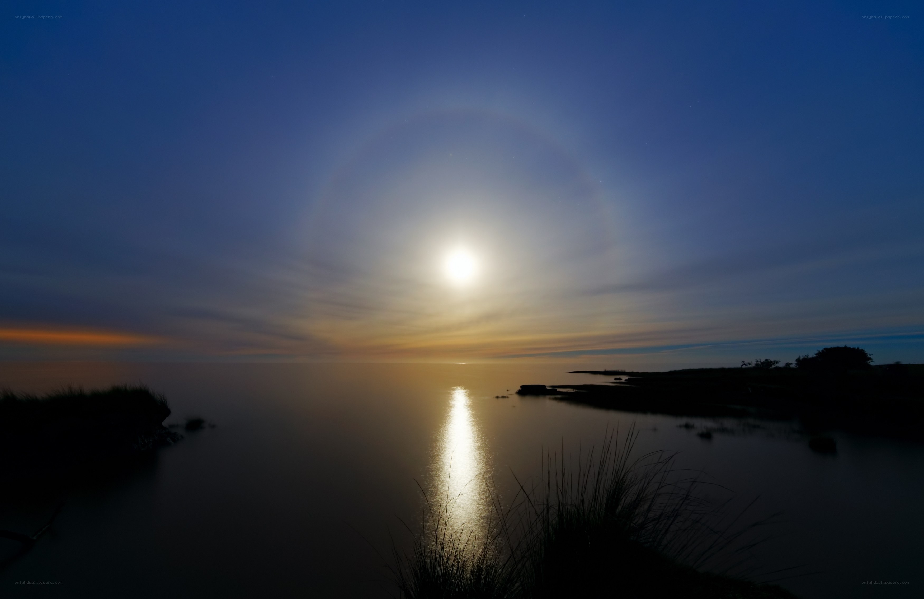 Moon halo over calm water