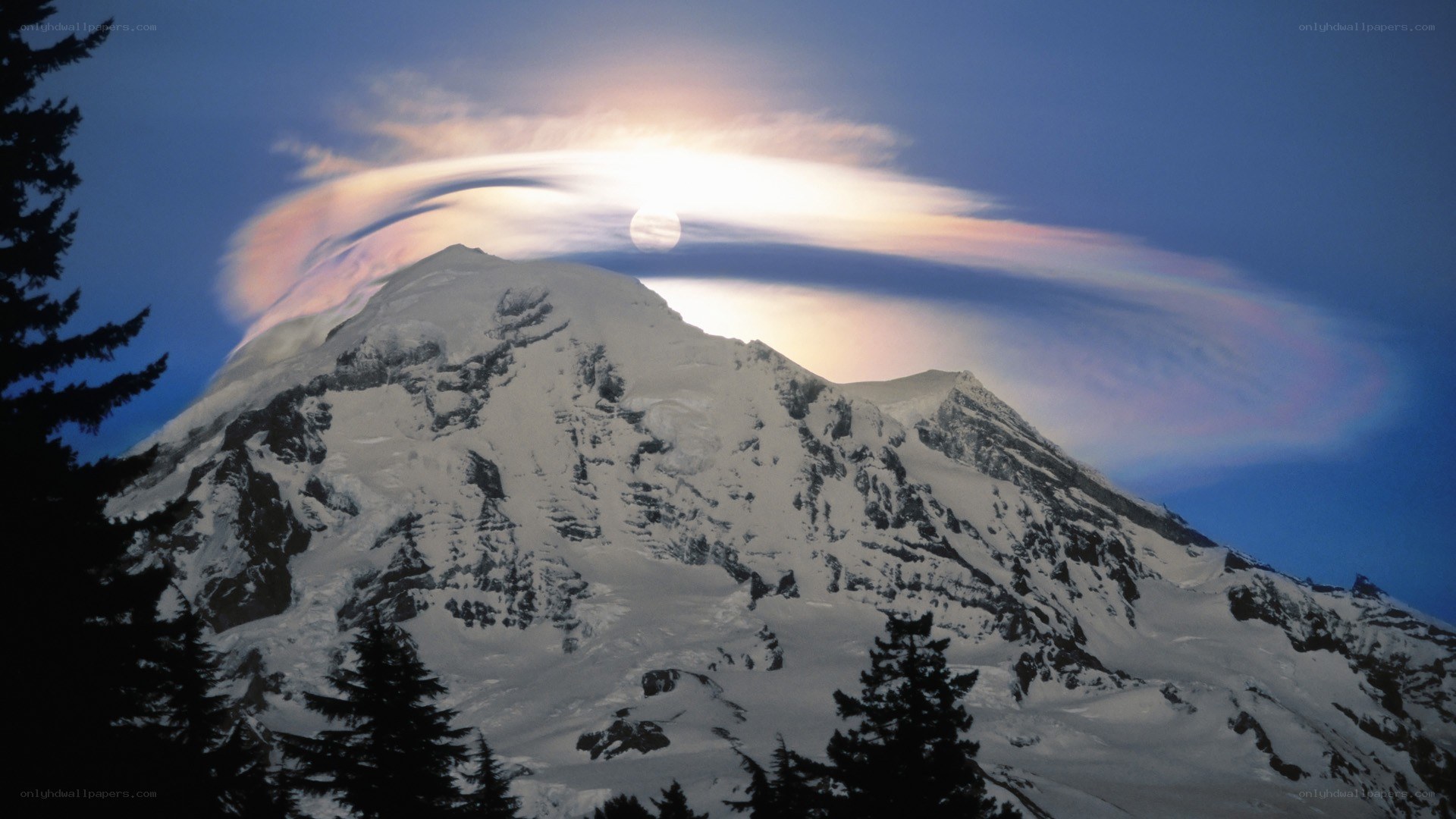 Moon halo over snow-capped mountain