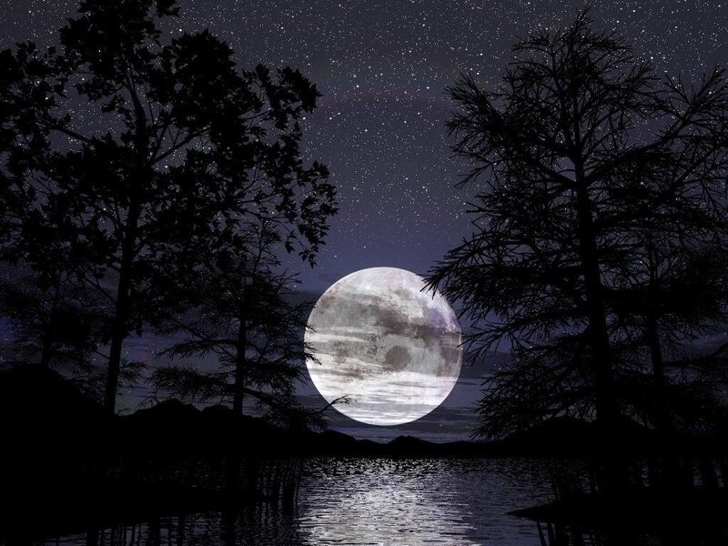 Moon over a lake at night
