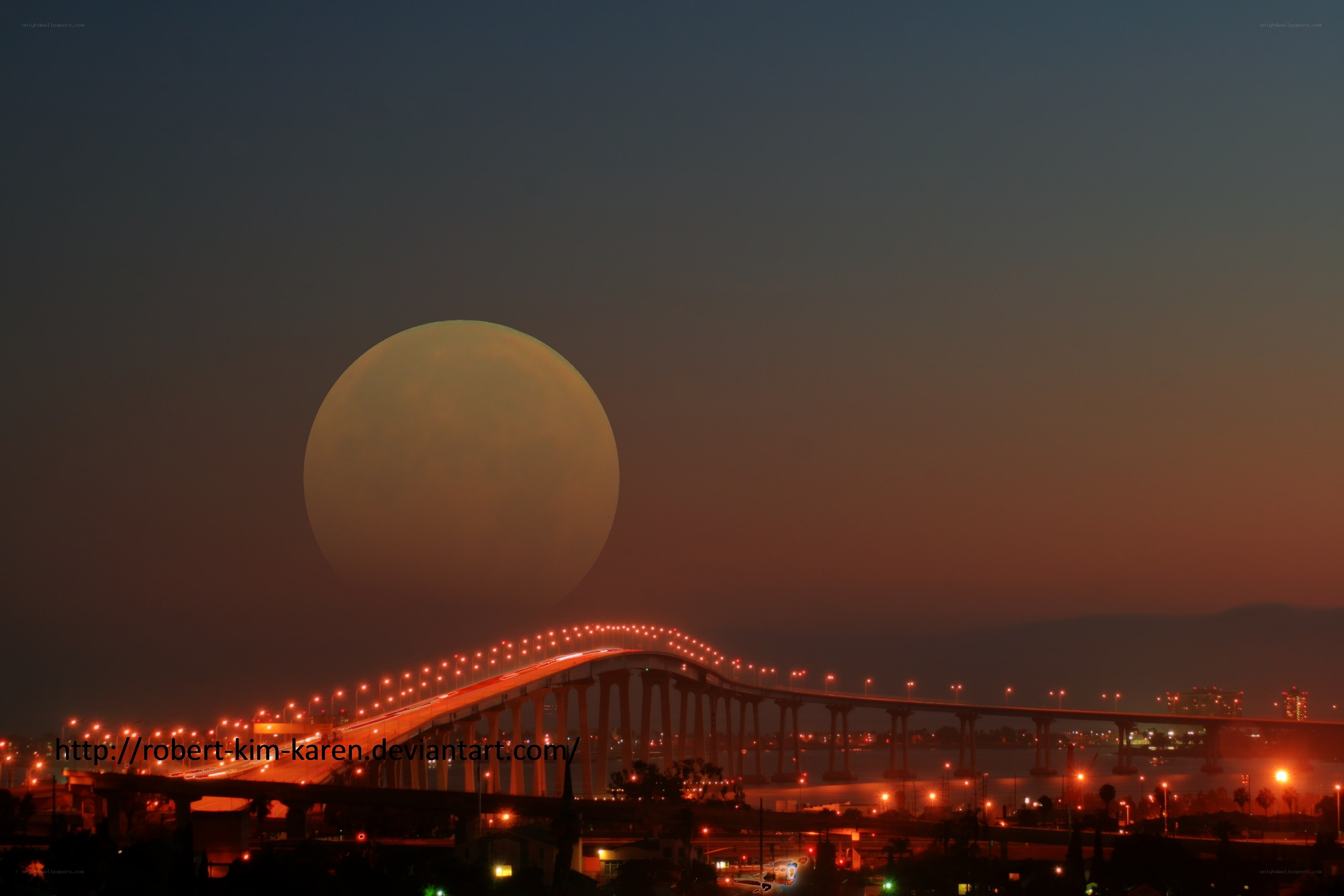 Moon over a lit bridge