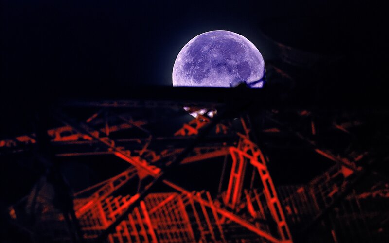 Moon over a red structure
