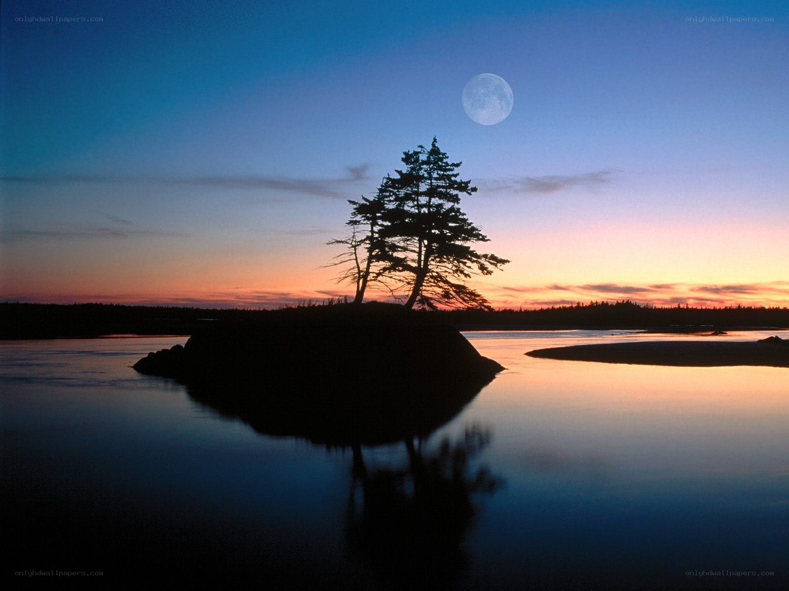 Moon over a silhouetted island