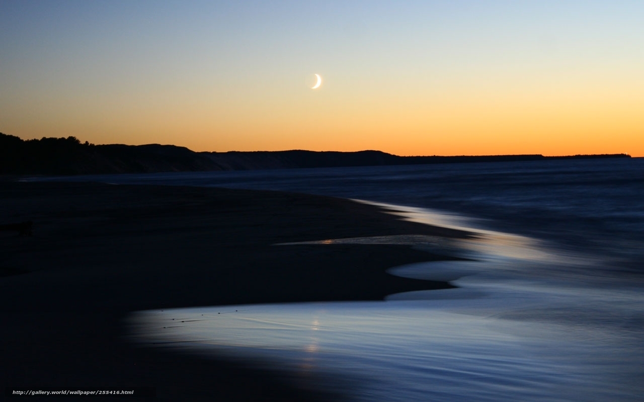 Moon over beach at dusk