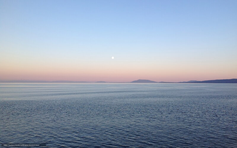 Moon over calm sea at dusk