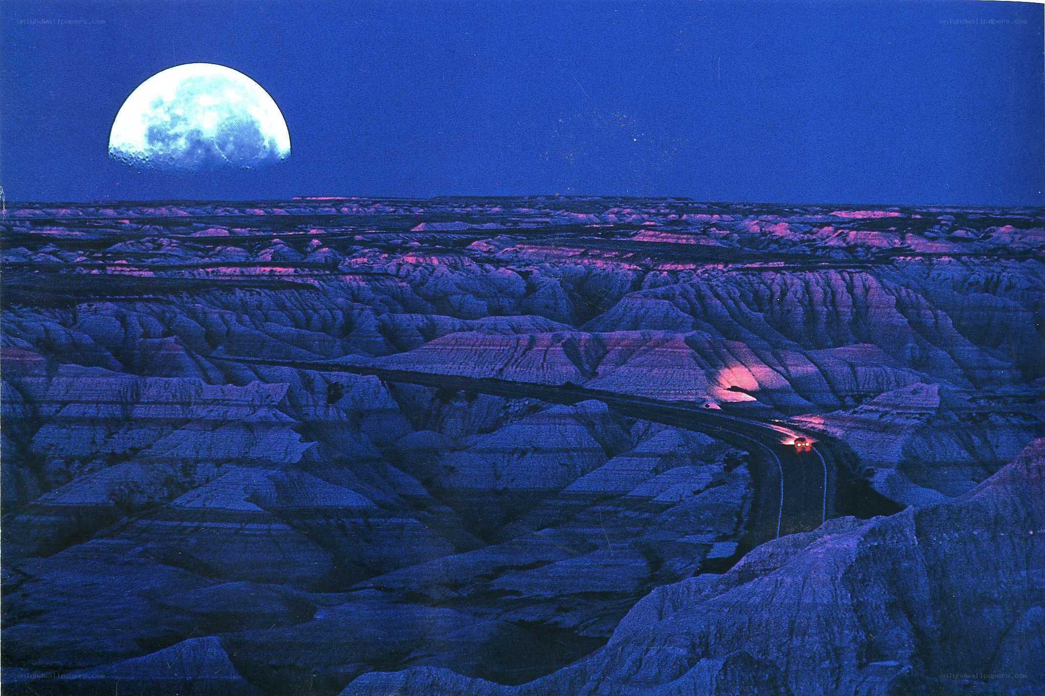 Moon over canyon landscape