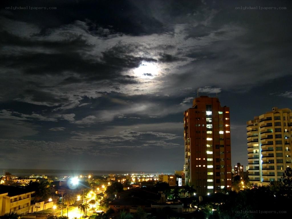 Moon over city at night