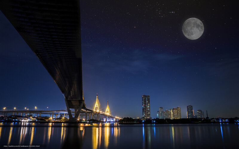 Moon over city bridge