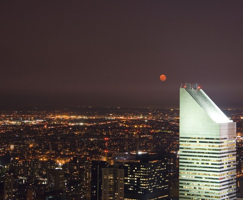 Moon over city skyline