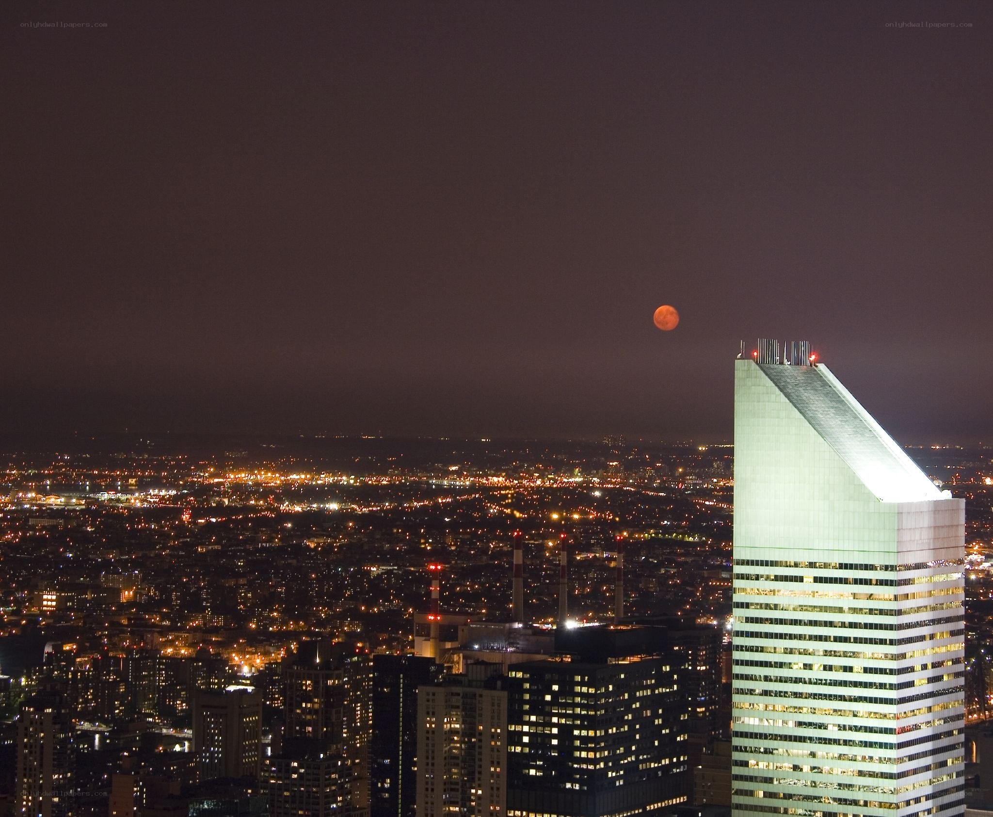 Moon over city skyline