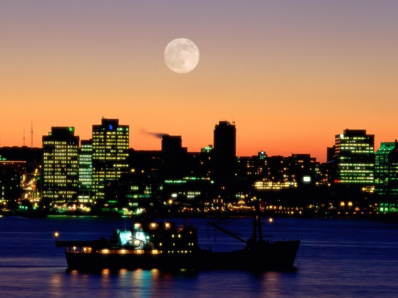 Moon over city skyline