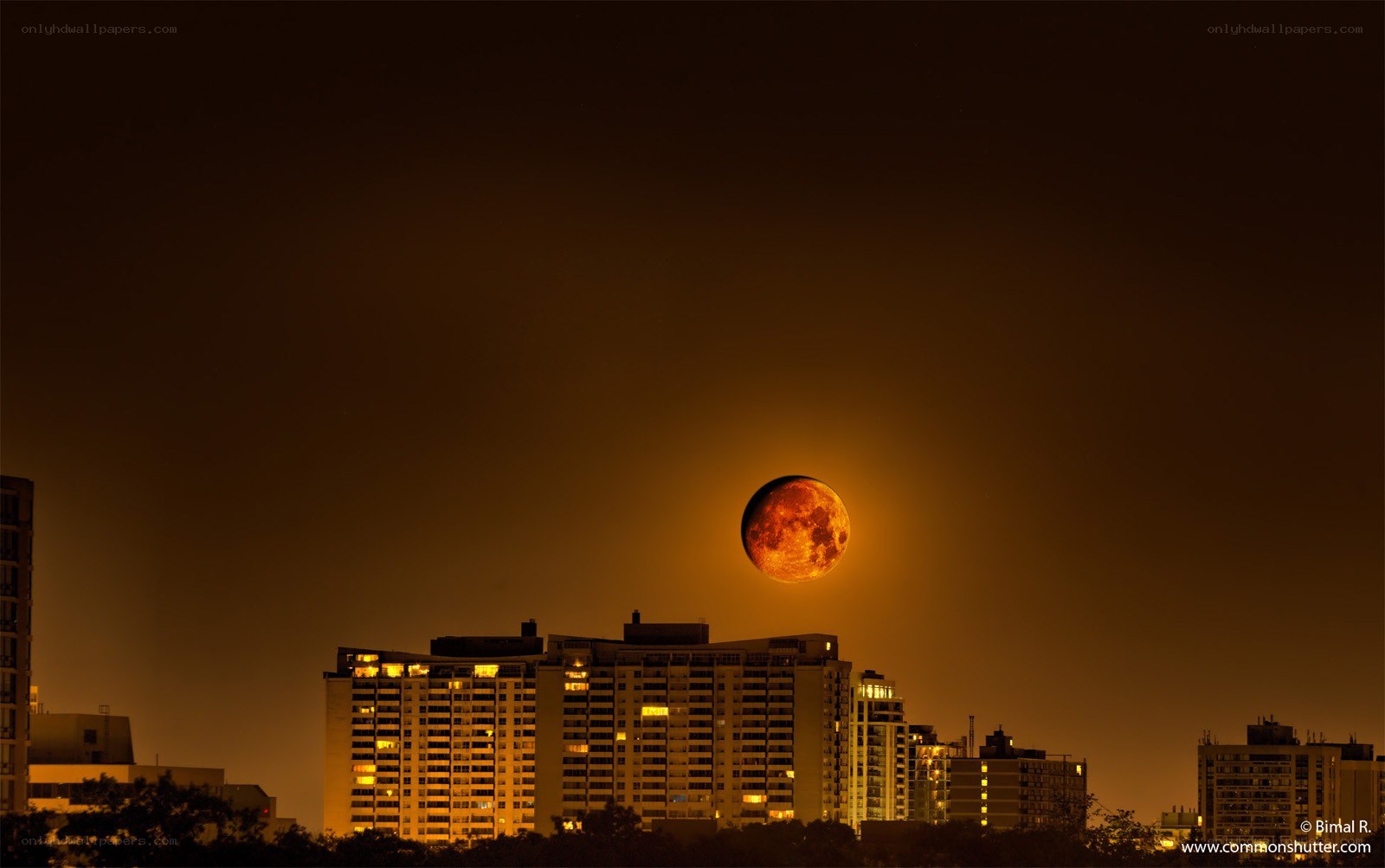 Moon over city skyline
