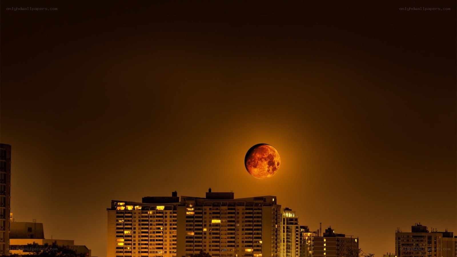 Moon over city skyline