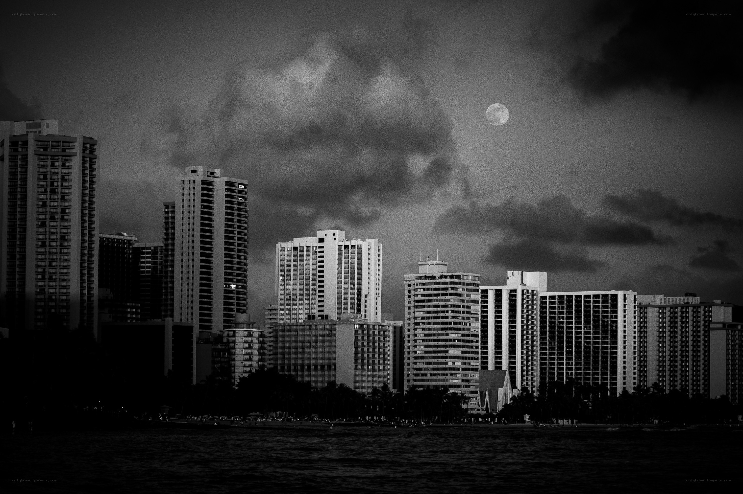 Moon over city skyline