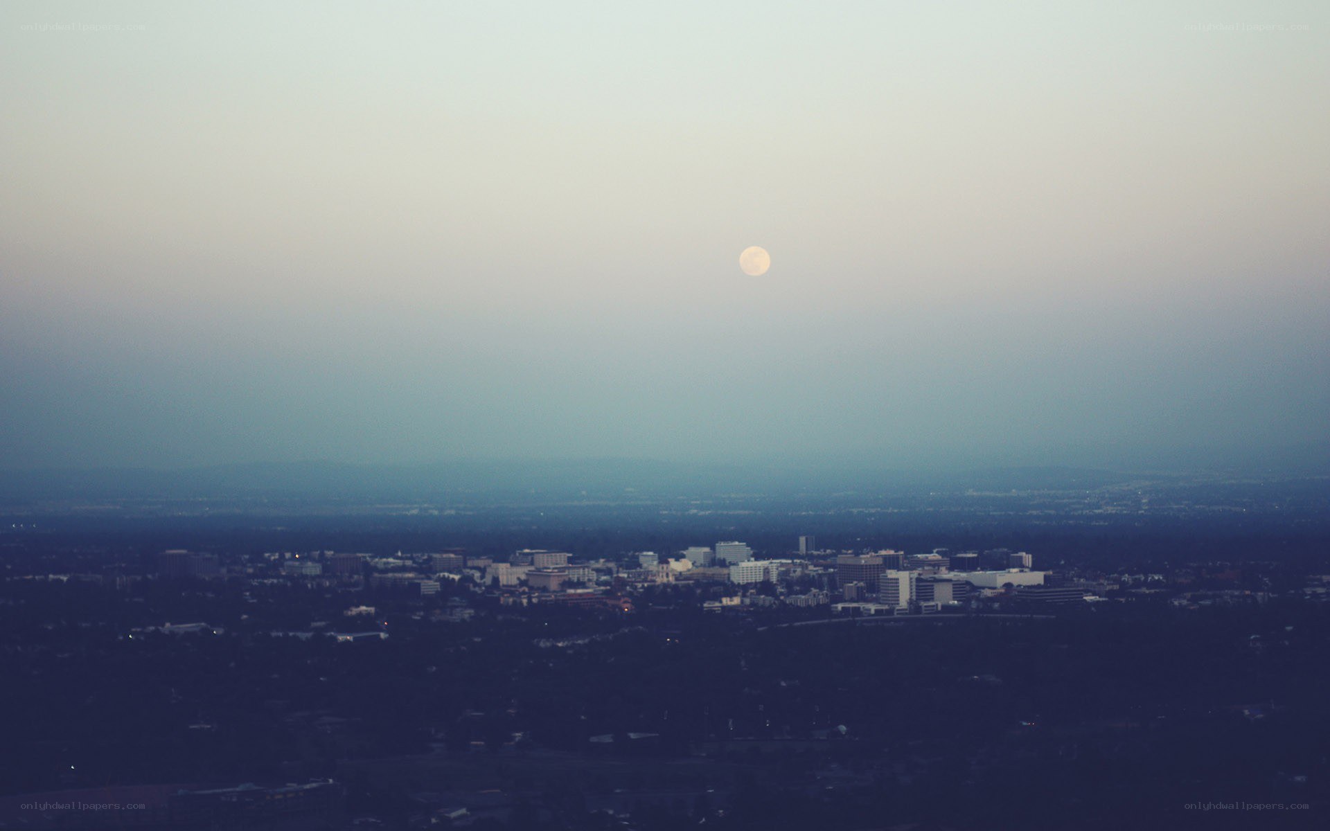 Moon over city skyline
