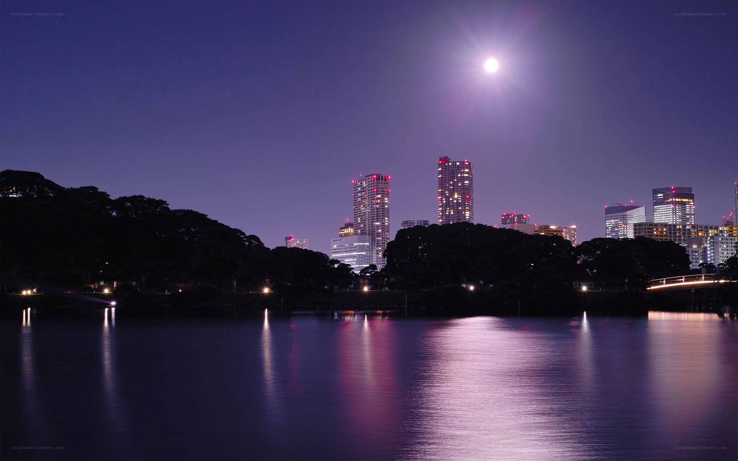 Moon over city skyline