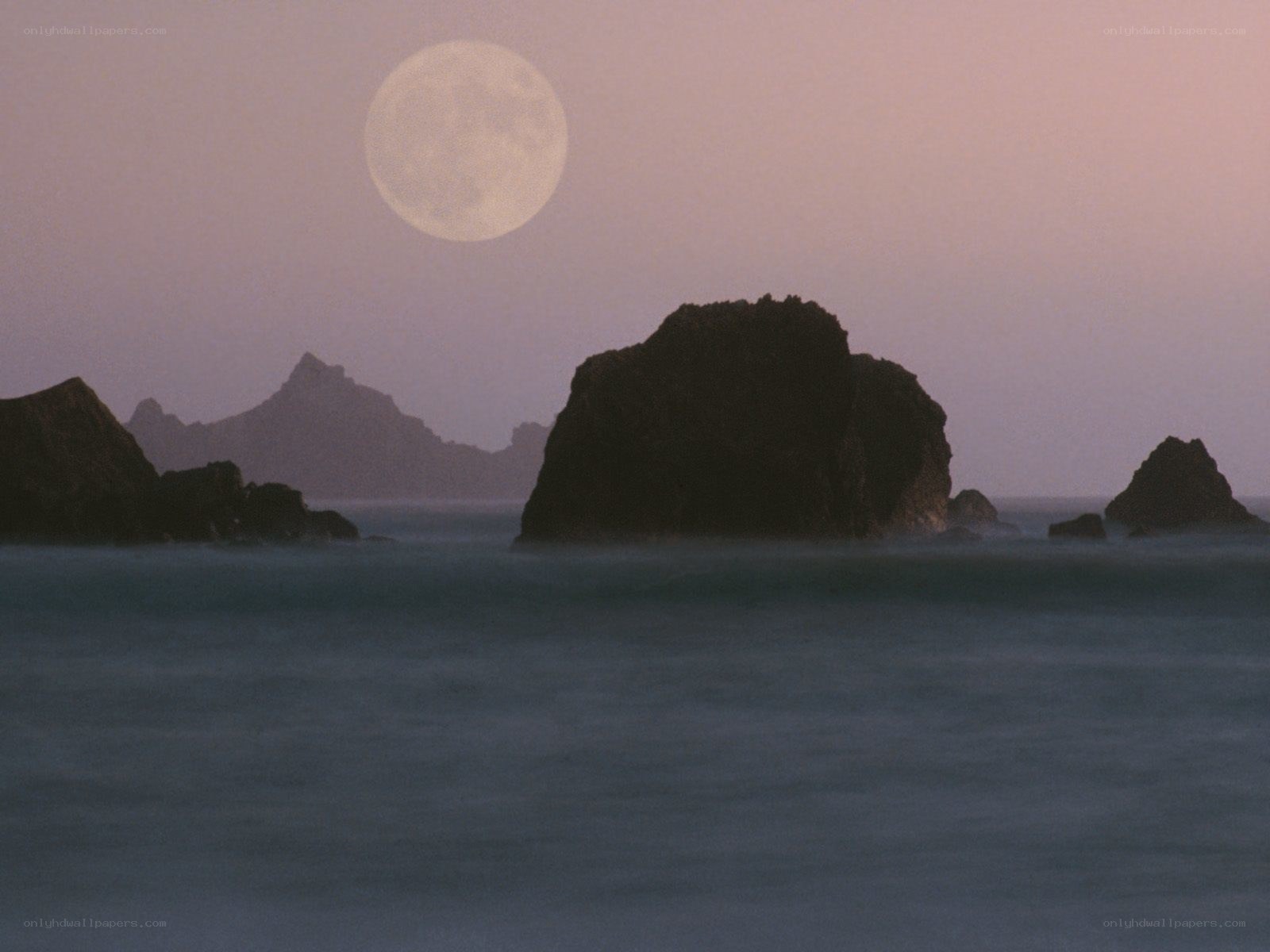 Moon over coastal rocks