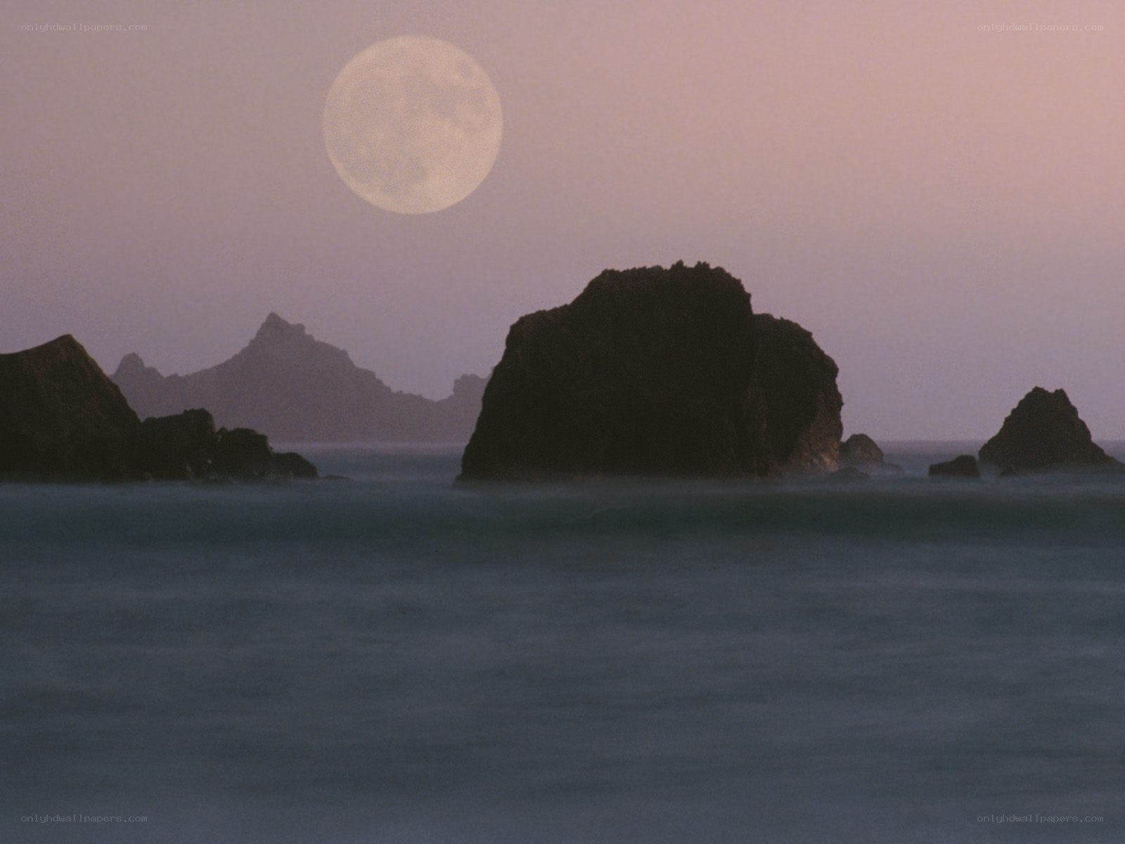 Moon over coastal rocks