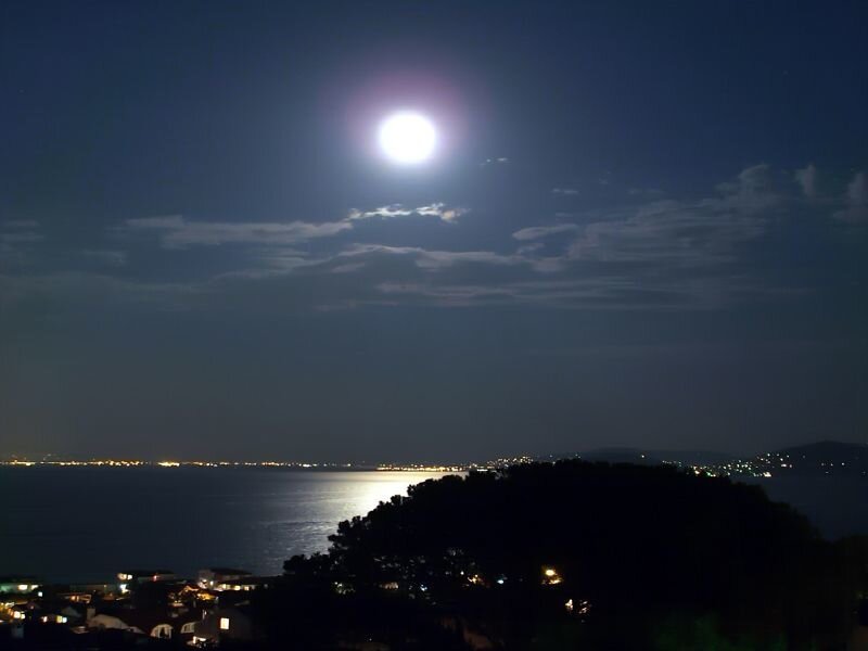Moon over coastal town