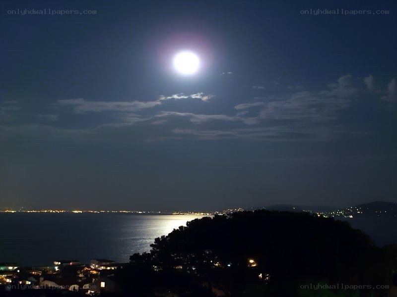 Moon over coastal town