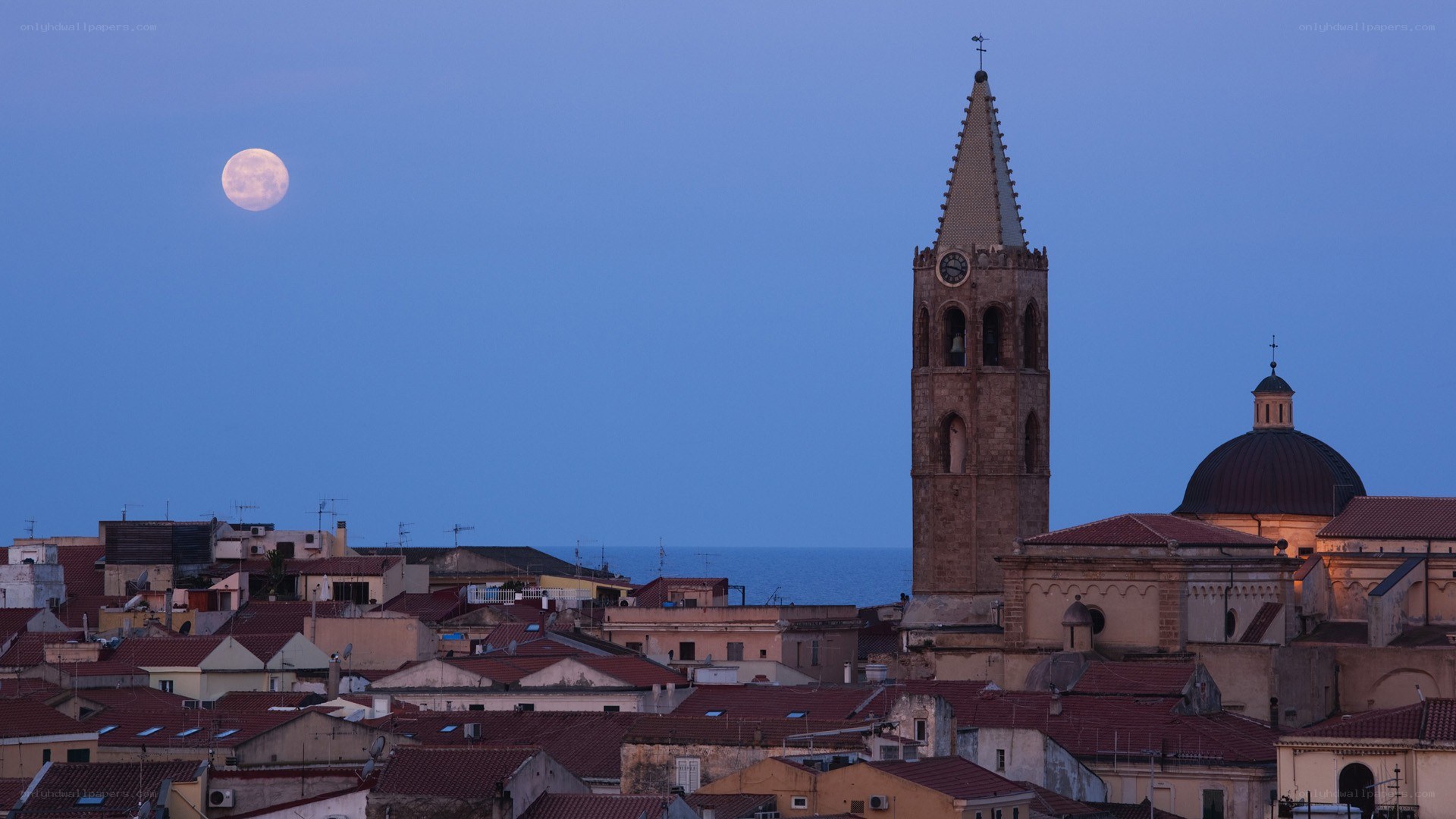 Moon over coastal town