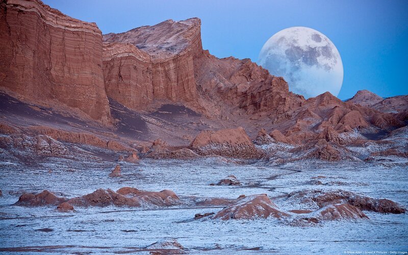 Moon over desert canyon