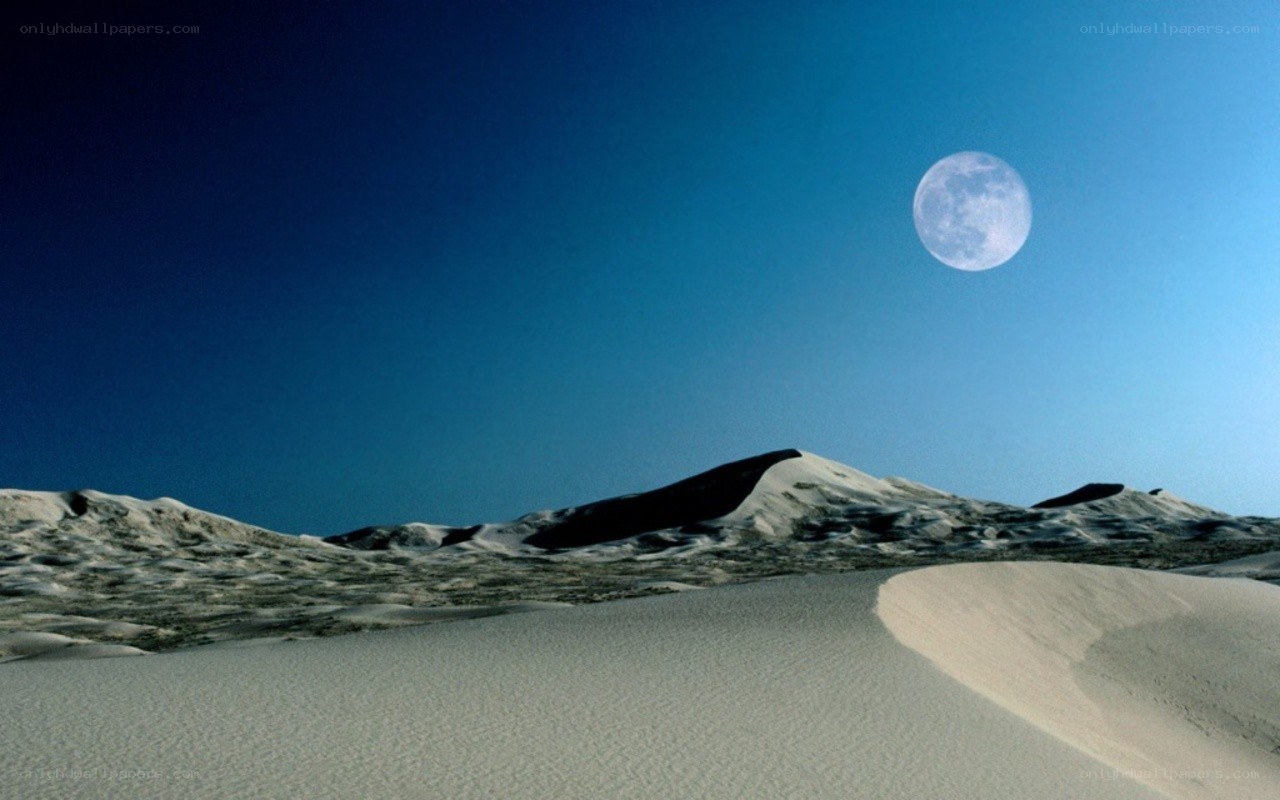 Moon over desert dunes