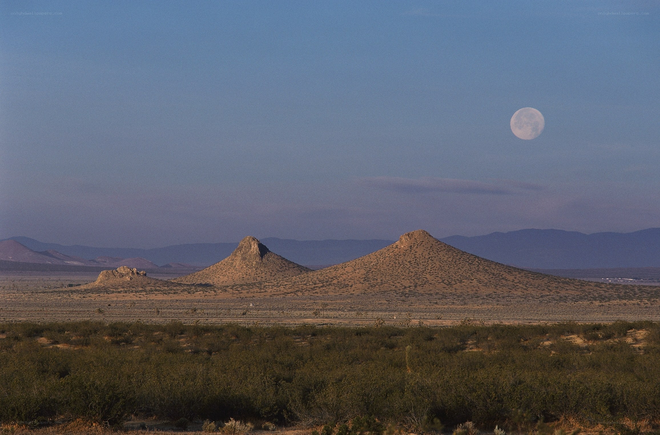 moon over desert hills