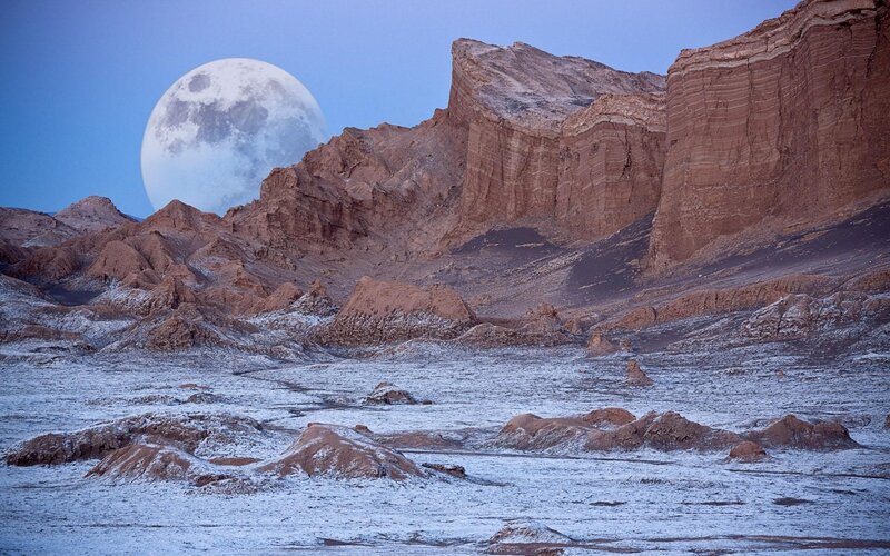 Moon over desert landscape