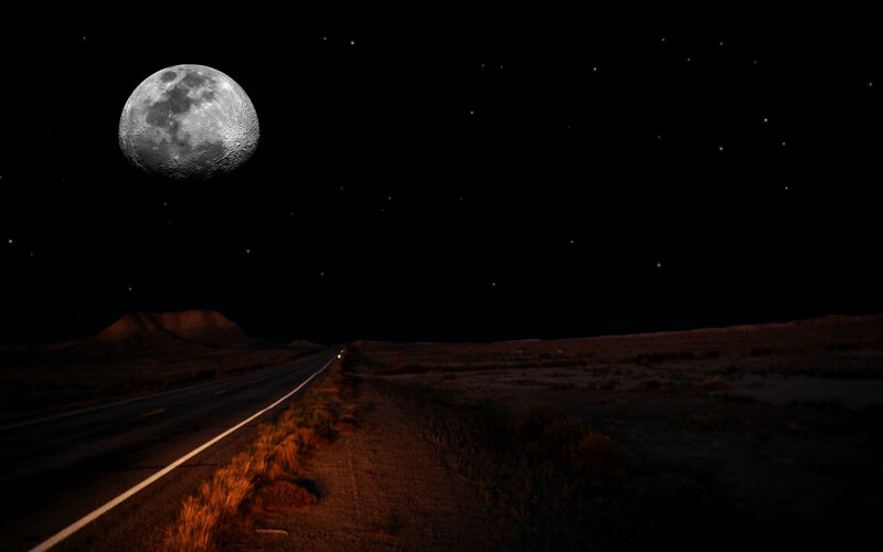 Moon over desert road