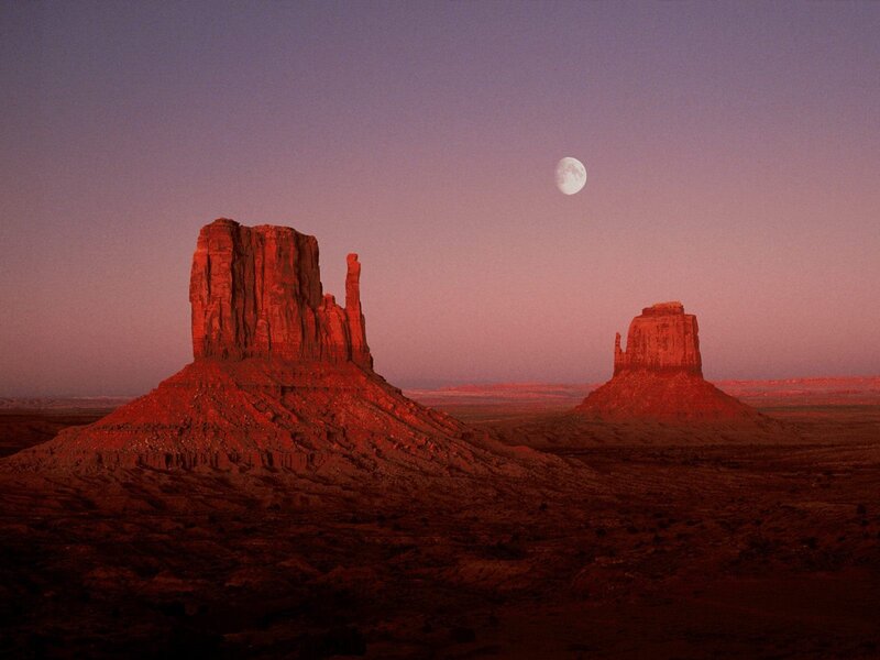 Moon over desert rock formations