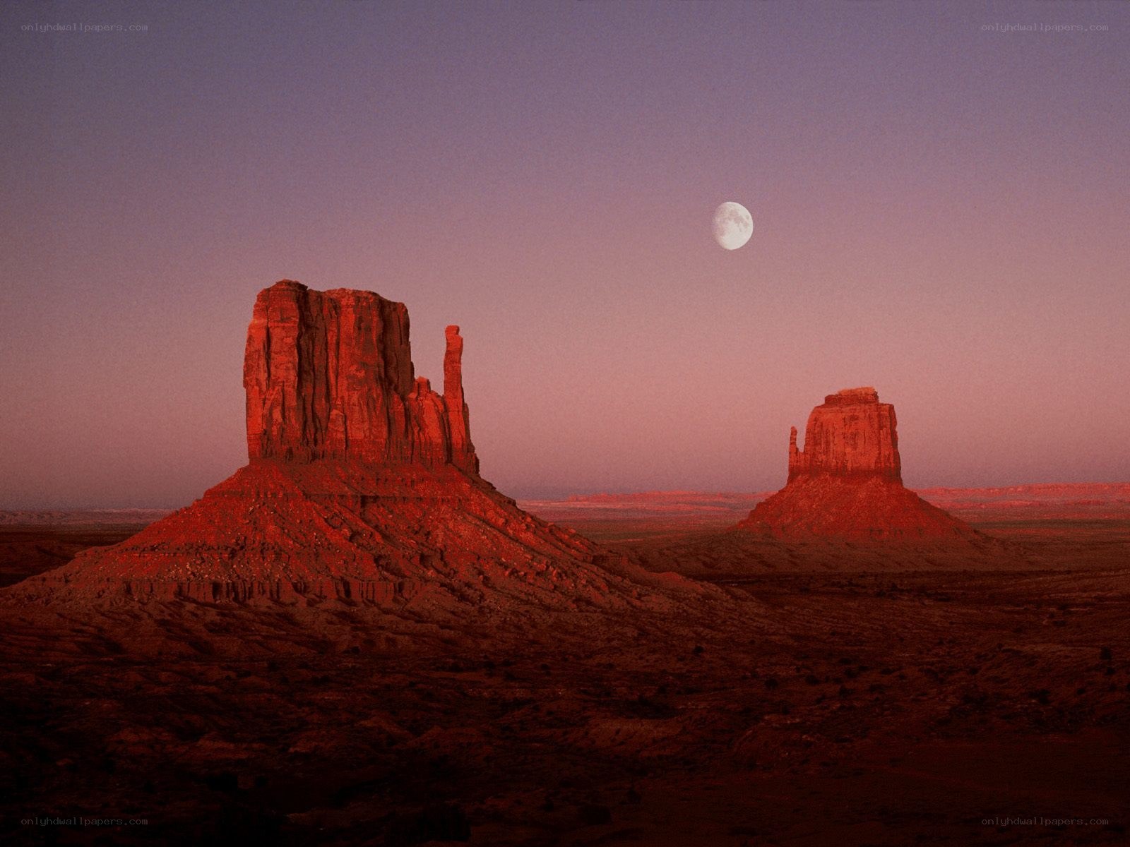 Moon over desert rock formations