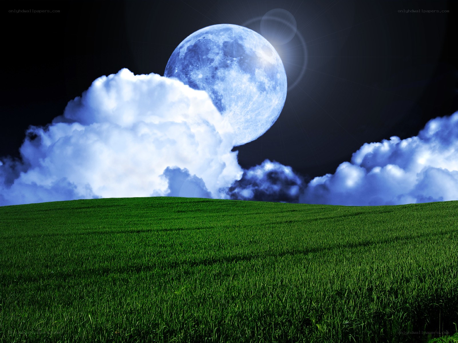 Moon over green field