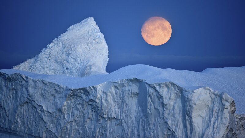 Moon over icebergs