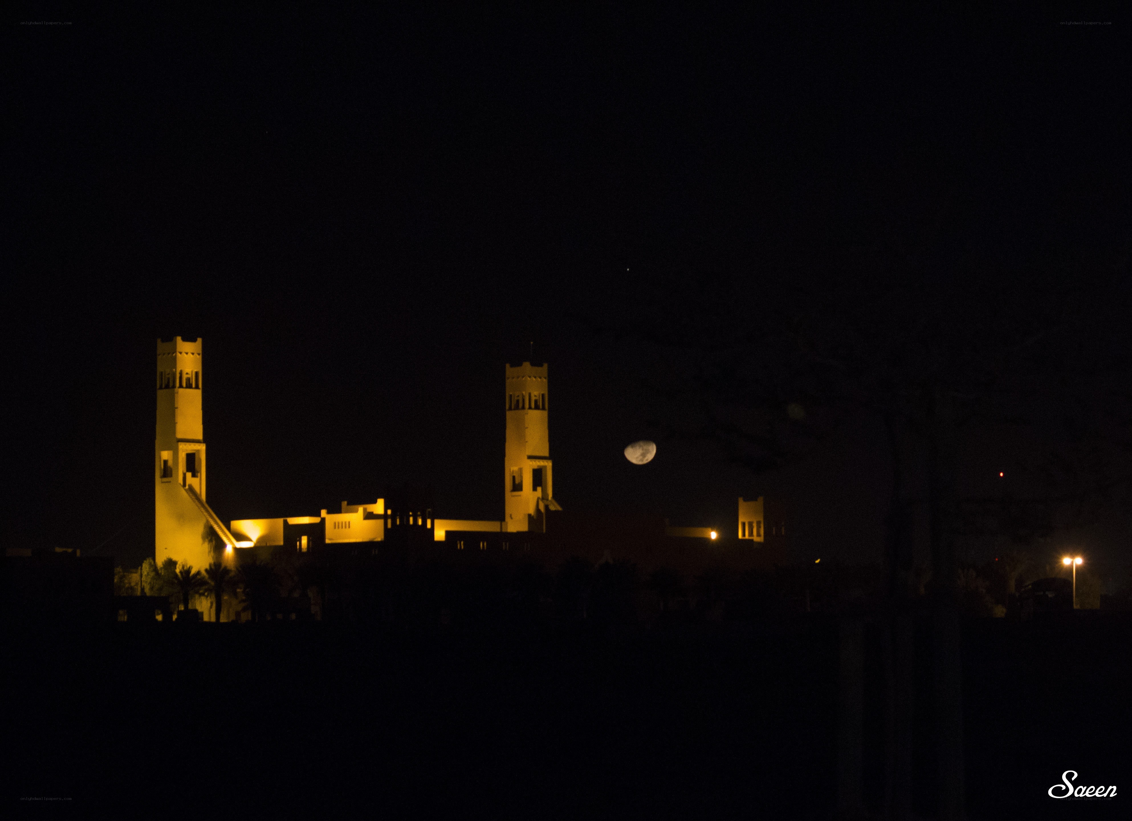 Moon over illuminated towers