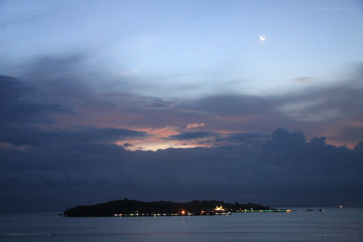 Moon over island at dusk