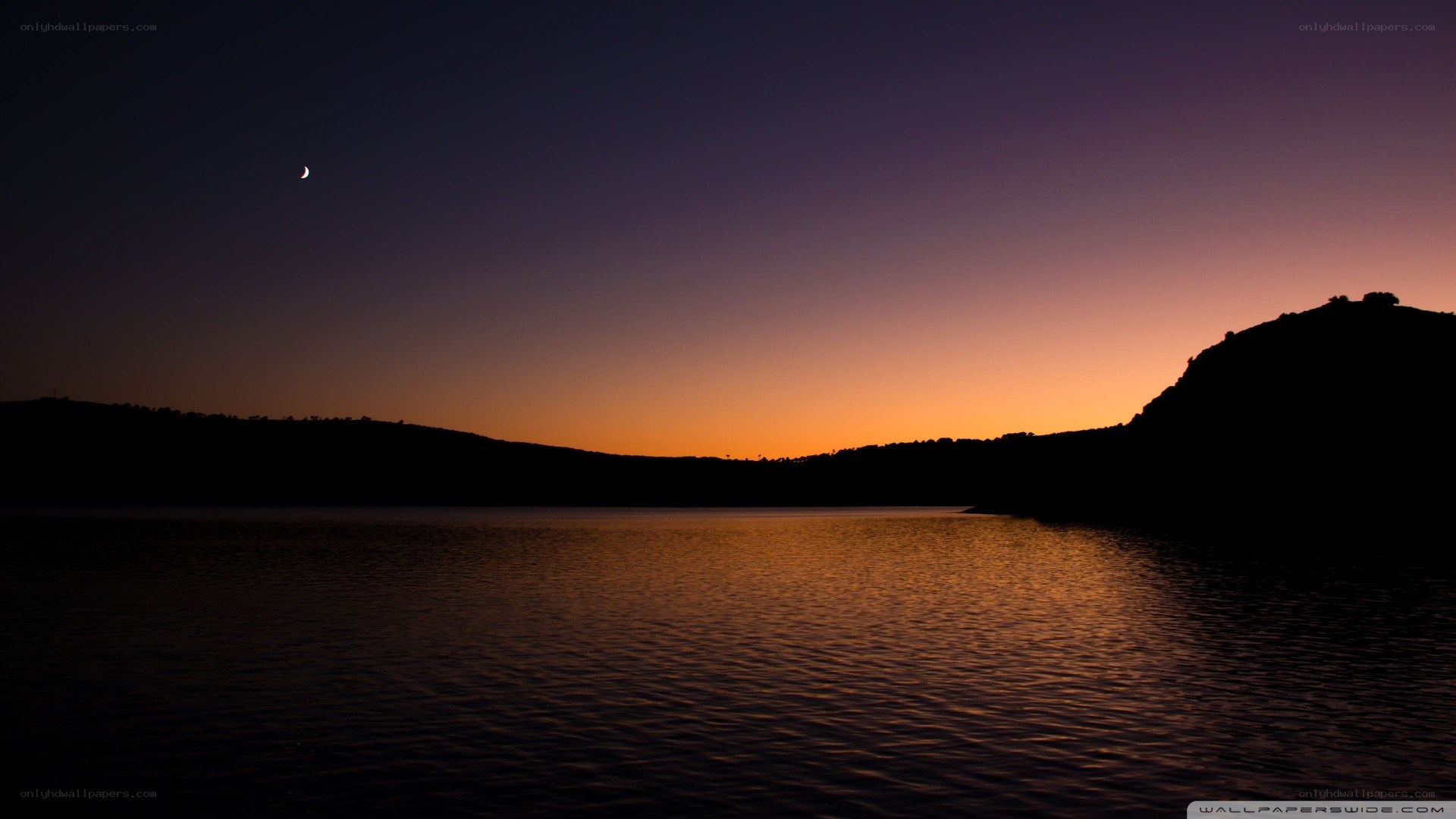 Moon over lake at dusk