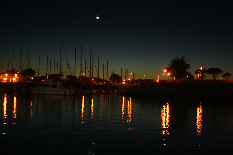 Moon over marina at dusk