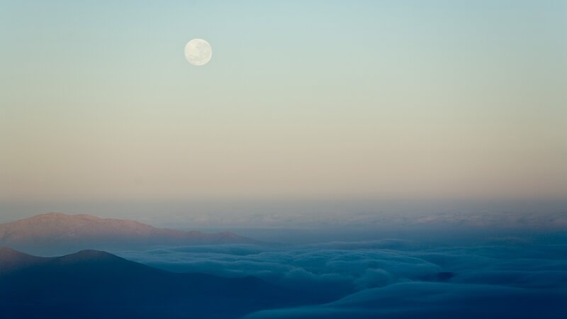 Moon over mountain clouds