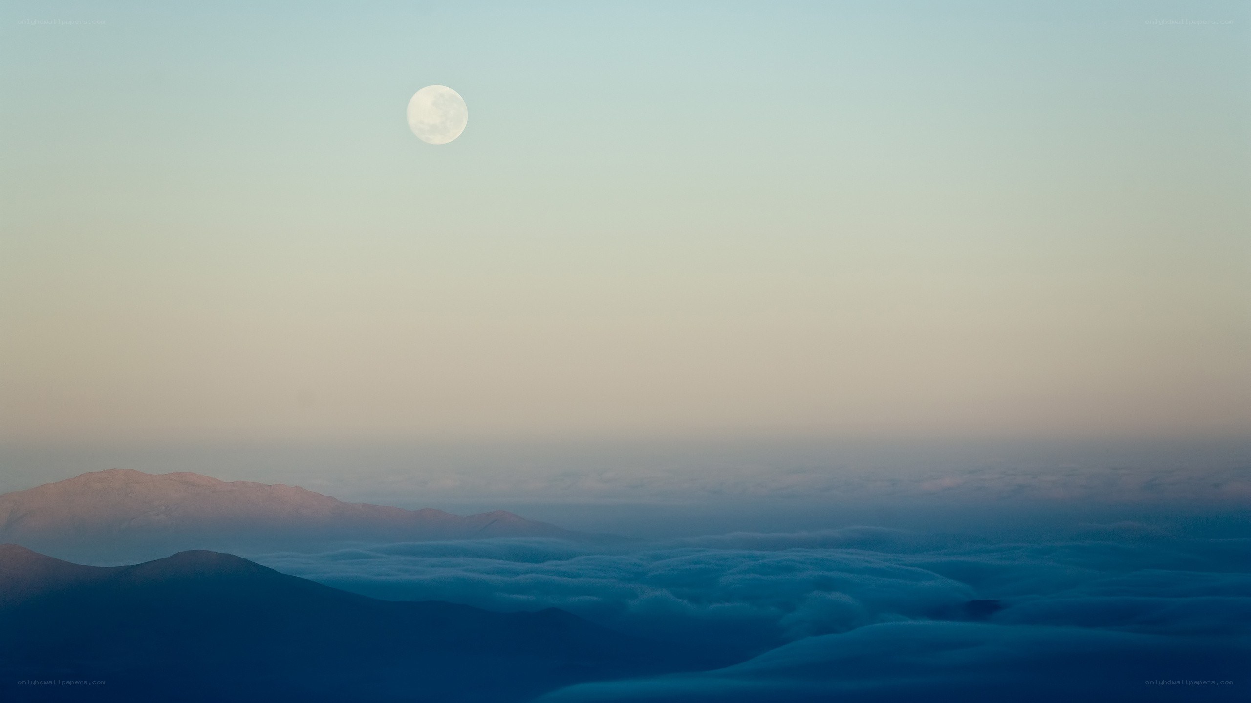 Moon over mountain clouds