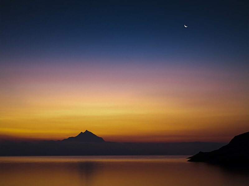 Moon over mountain lake