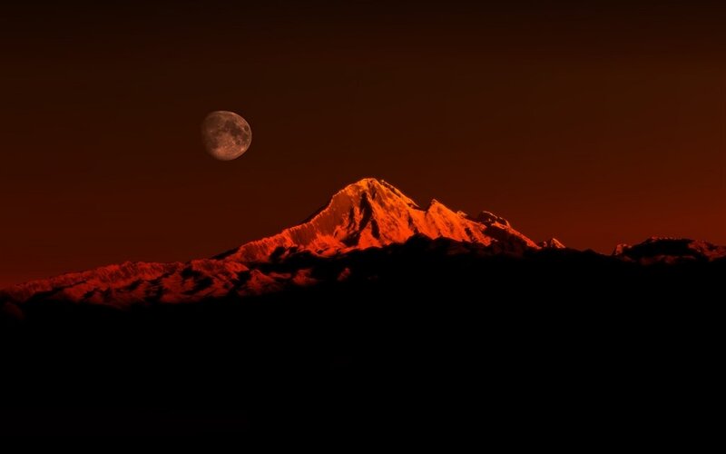 Moon over mountain peak