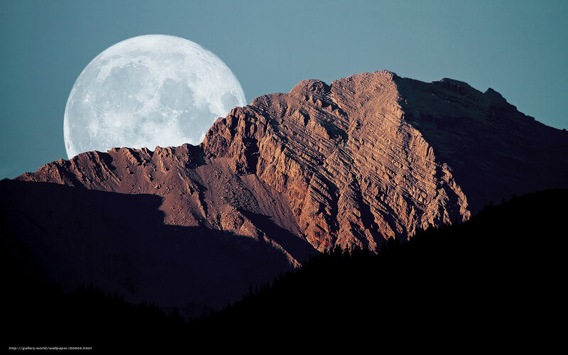Moon over mountain peak