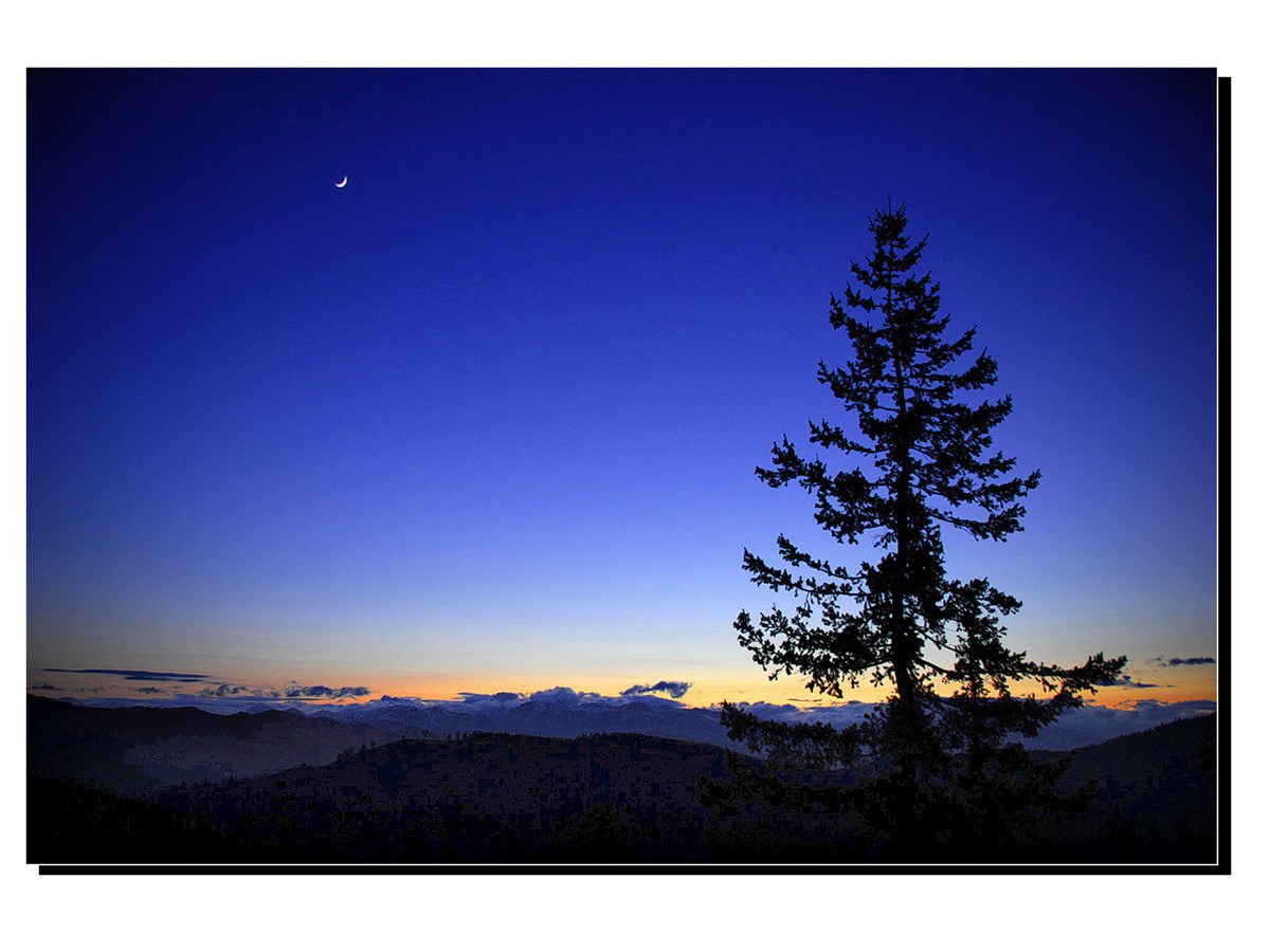 Moon over mountain silhouette