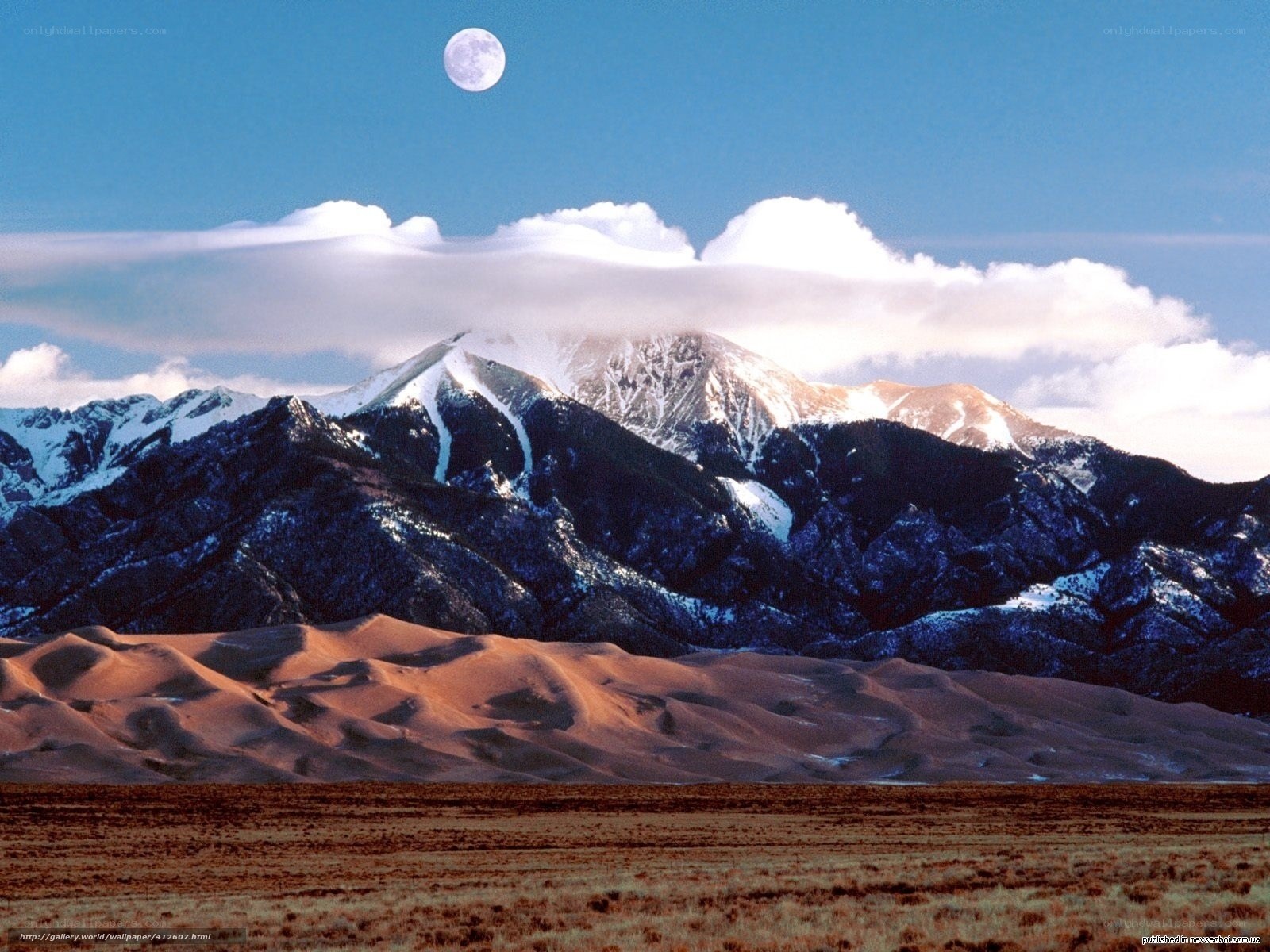 Moon over mountains and dunes
