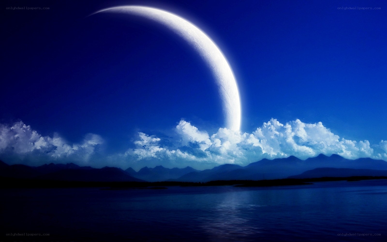 Moon over mountains and sea