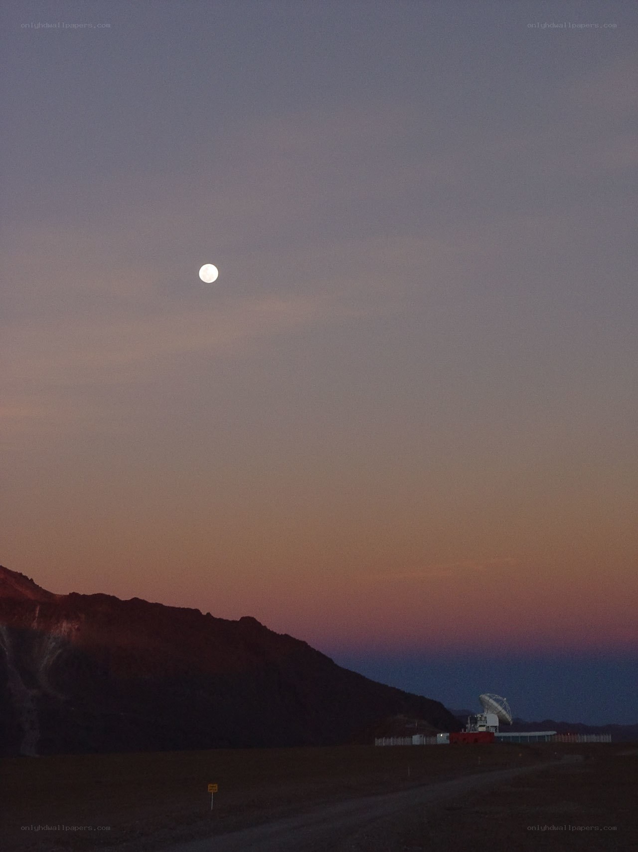 Moon over observatory at dusk