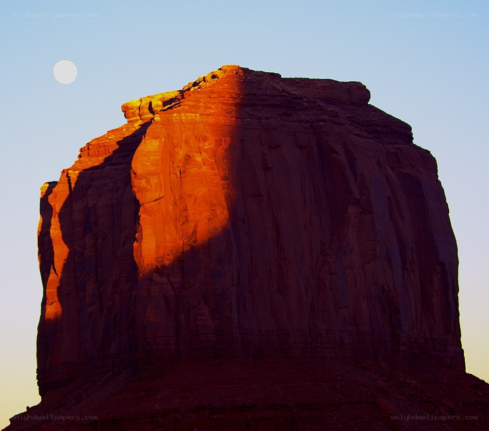 Moon over red rock formation