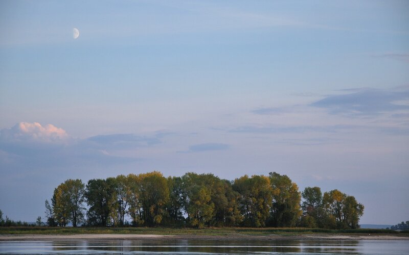 Moon over river island